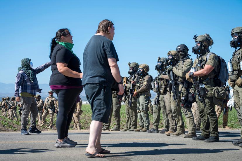 Protesters standoff against federal immigration agents during a raid in the agriculture area of Camarillo, Calif.