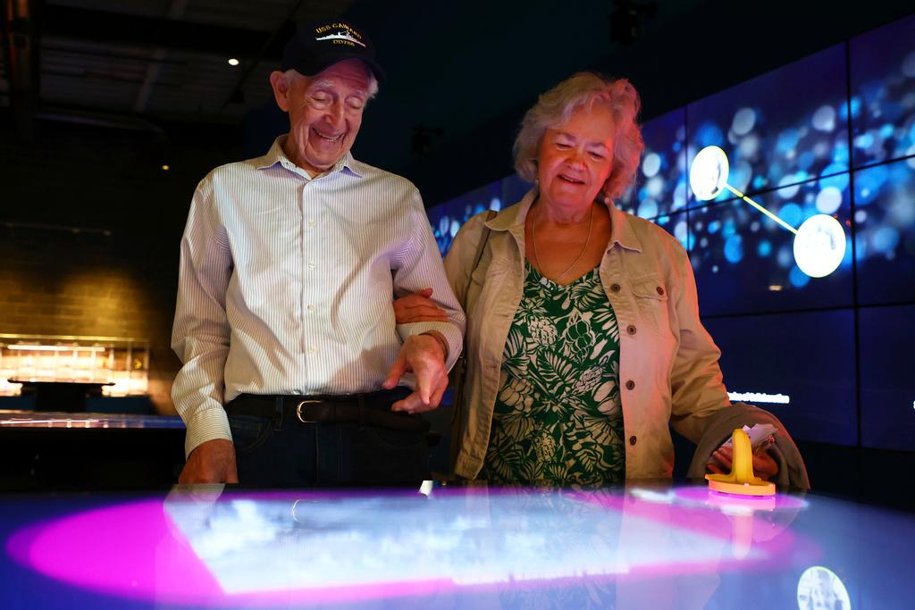 Mario and Gail Cirasunda, of Orchard Park, N.Y., interact with one of the museum's touch screen exhibits during a Memory Cafe event 