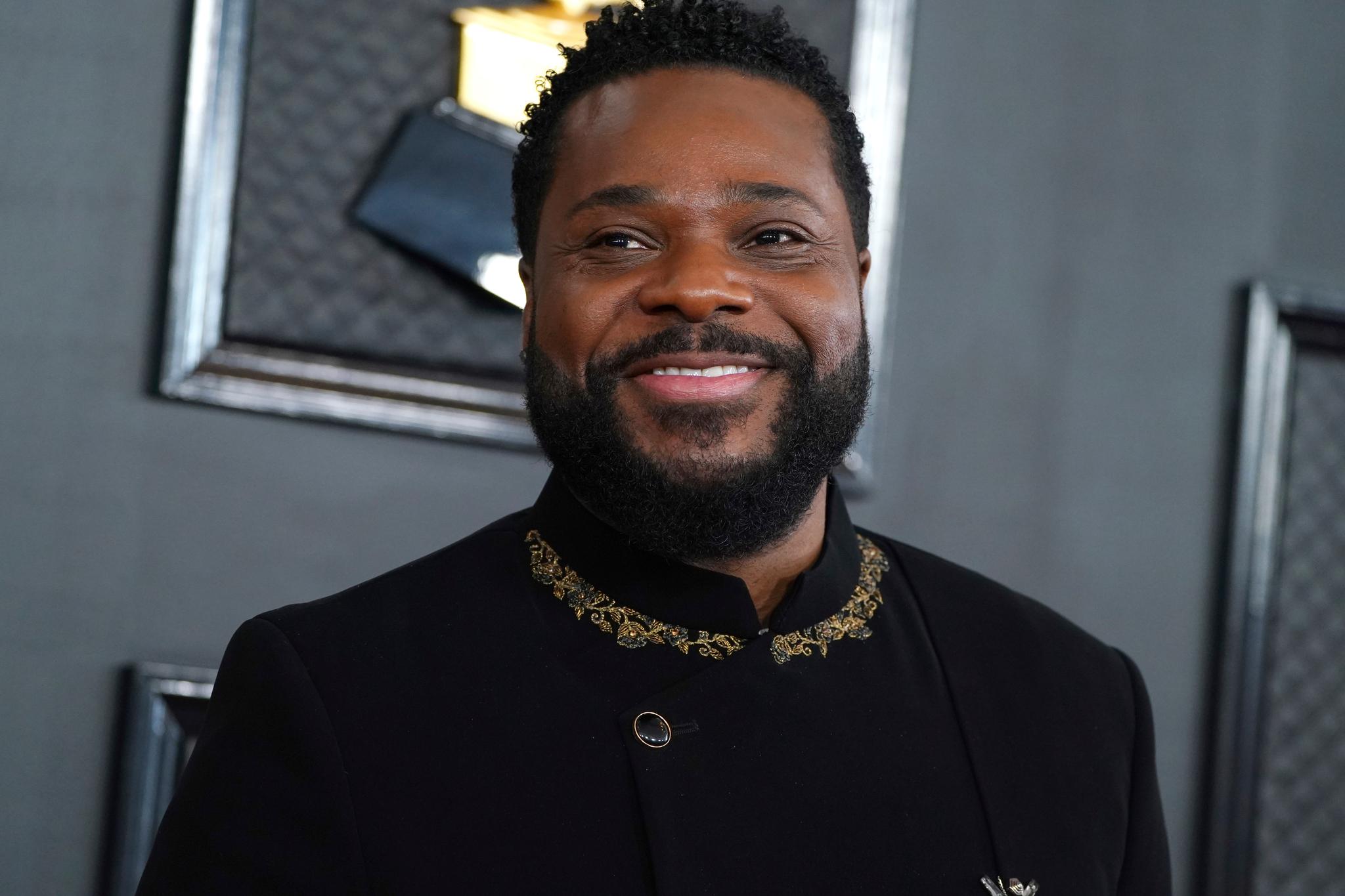 Smiling man in a suit.