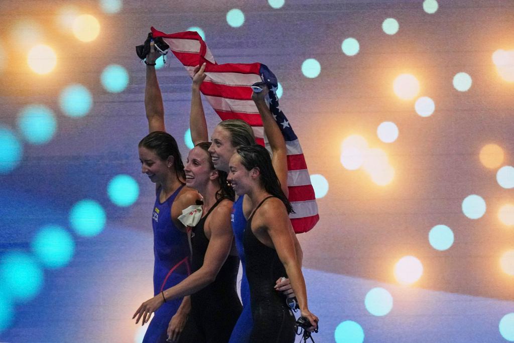 Athletes of team United States celebrate after winning gold medal in the women's 4x100-meter medley relay final at the World Aquatics Championships in Singapore
