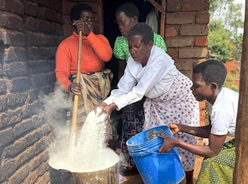 Making Nsima, a staple made from maize. Malawi