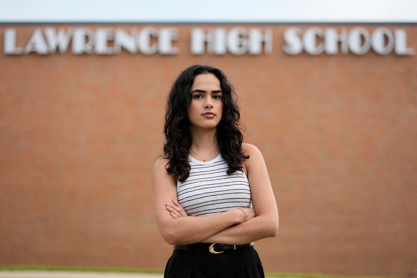 Natasha Torkzaban stands outside Lawrence High School, where she and other students have filed a lawsuit against the school district's use of digital surveillance software in Lawrence, Kan. 