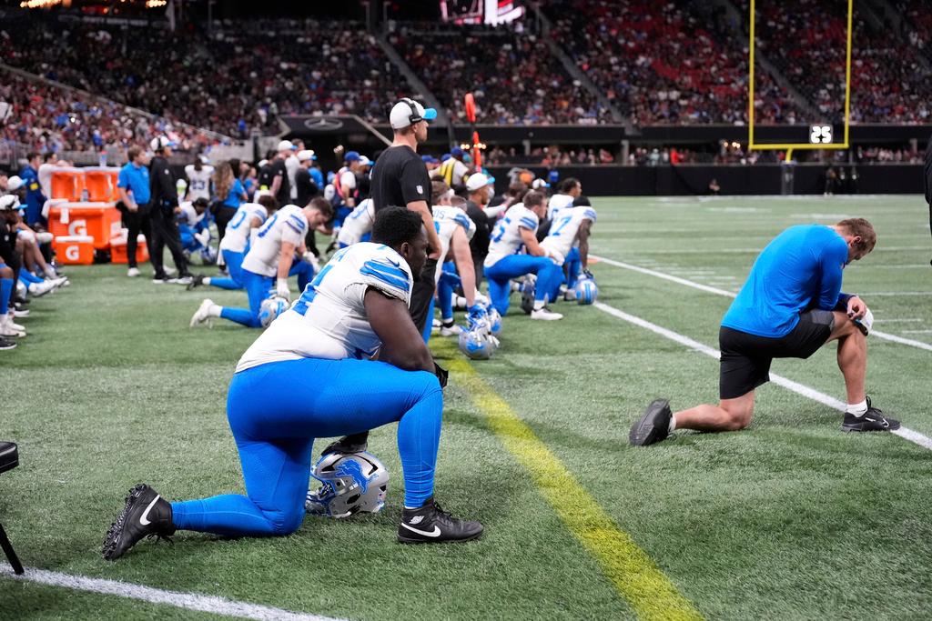 Detroit Lions players take a knee after safety Morice Norris was injured against the Atlanta Falcons during the second half of an NFL preseason football game 
