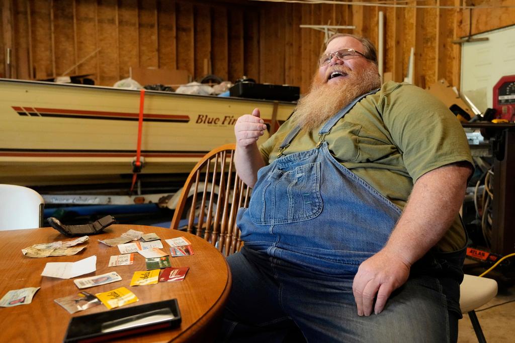 Richard Guilford in front of items found in his lost wallet in Petersburg, Mich. 