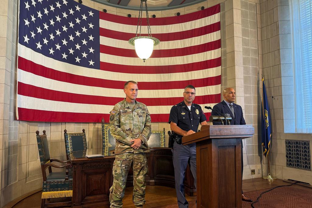 Nebraska State Patrol Superintendent Colonel Bryan Waugh, center, flanked by National Guard Adjutant General Maj. Gen. Craig W. Strong, left, and Department of Correctional Services Director Rob Jeffreys