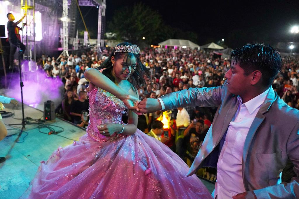 Isela Anali Santiago Morales dances during her 15th birthday party at a stadium in Axtla de Terrazas, Mexico