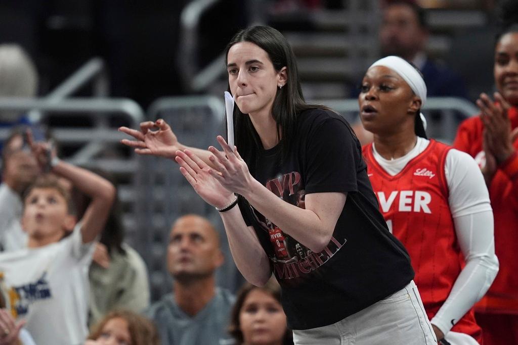 Indiana Fever's Caitlin Clark cheers during the first half of a WNBA basketball game 