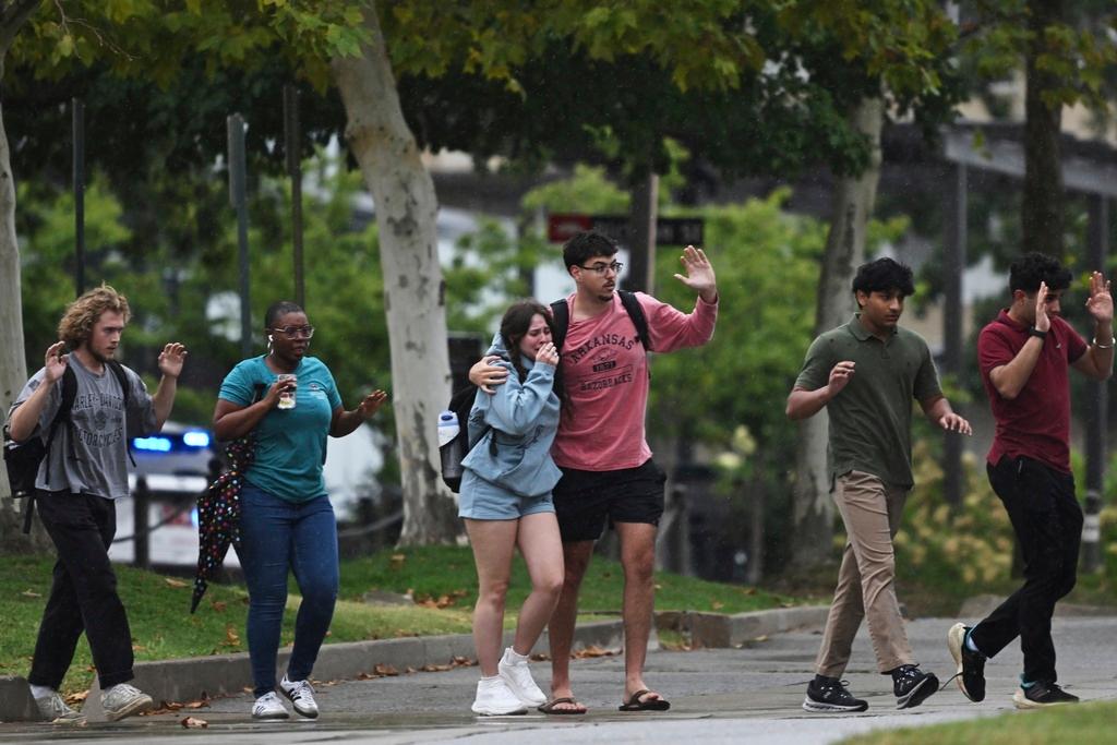 University of Arkansas students and employees evacuate and take shelter in Fayetteville, Ark., as police respond to reports of a shooting.