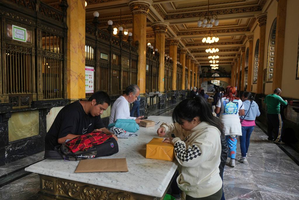 People prepare packages to send at the Main Post Office in Mexico City