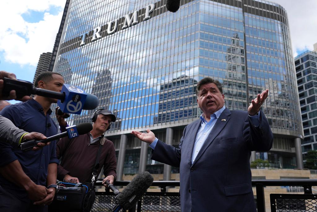 Illinois Governor JB Pritzker speaks at a news conference in a Chicago water taxi 