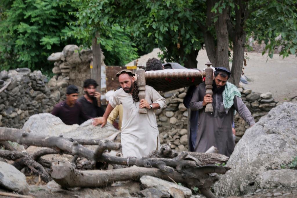 Injured person is carried to a military helicopter that landed to evacuate injured victims of an earthquake that killed many people and destroyed villages in eastern Afghanistan