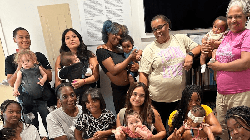 A group of YoungLives mothers and leaders alongside Adriene Perry (center, right)