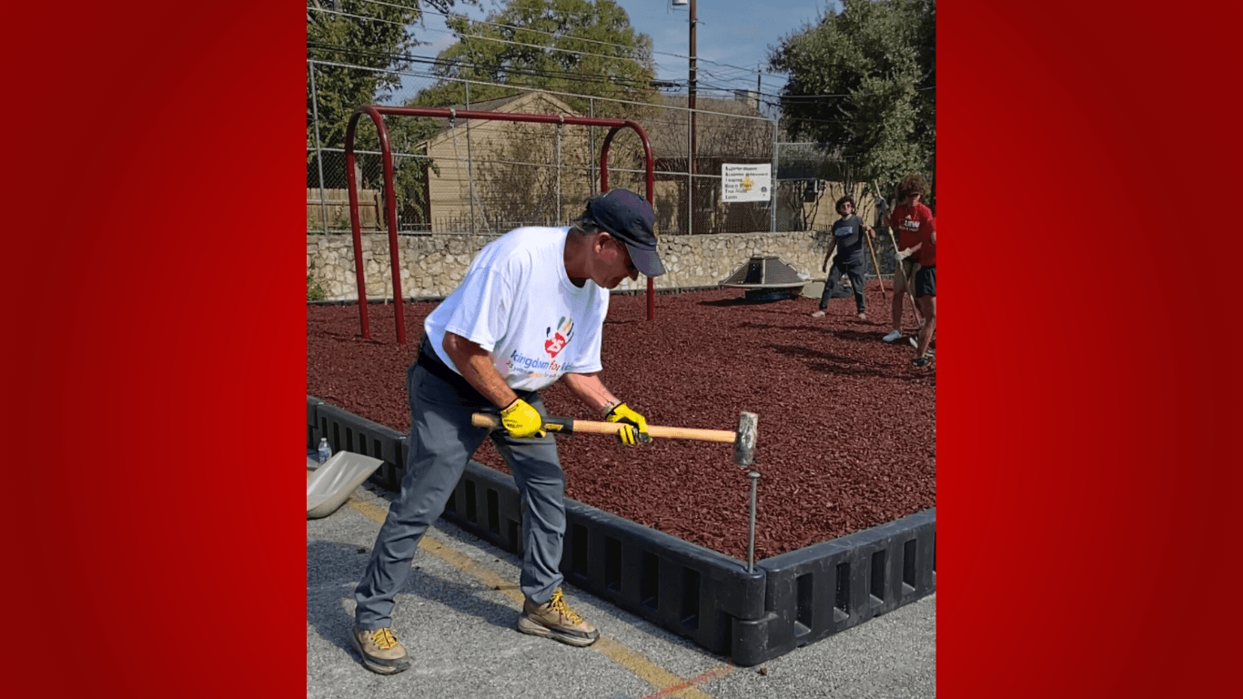 Rick Cavender drops the hammer on the final rod holding together a new playground area. 
