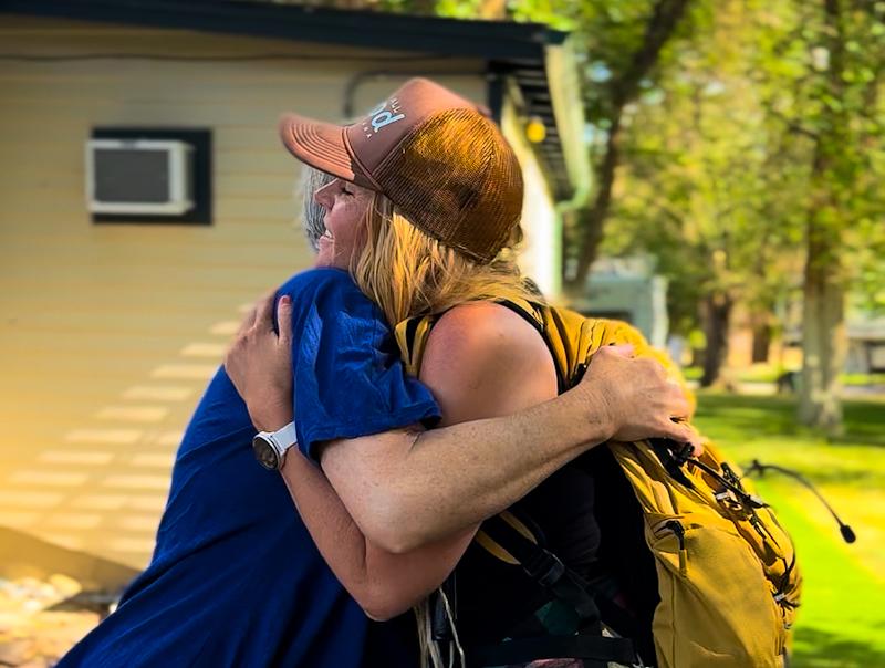Britney Higgs  hugs woman