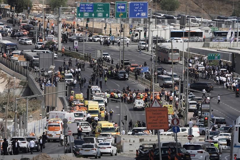 Israeli police and rescue teams respond at the scene of a shooting attack 