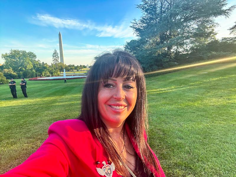 Debra takes a selfie with the Washington Monument on a trip to D.C. - " I was personally invited there on September 12, 2024 By President Biden to acknowledge my service in anti-trafficking."
