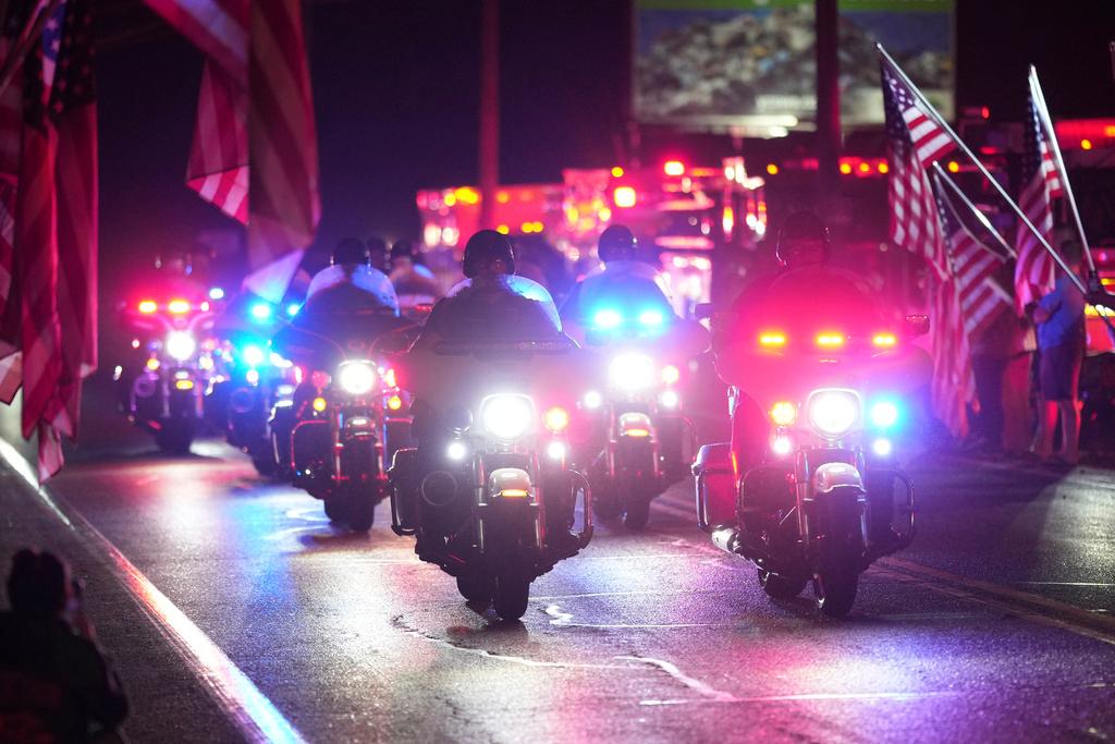 Police officers ride during a procession Wednesday, Sept. 17, 2025, in Spring Grove, Pa., after multiple police officers were shot and killed. 