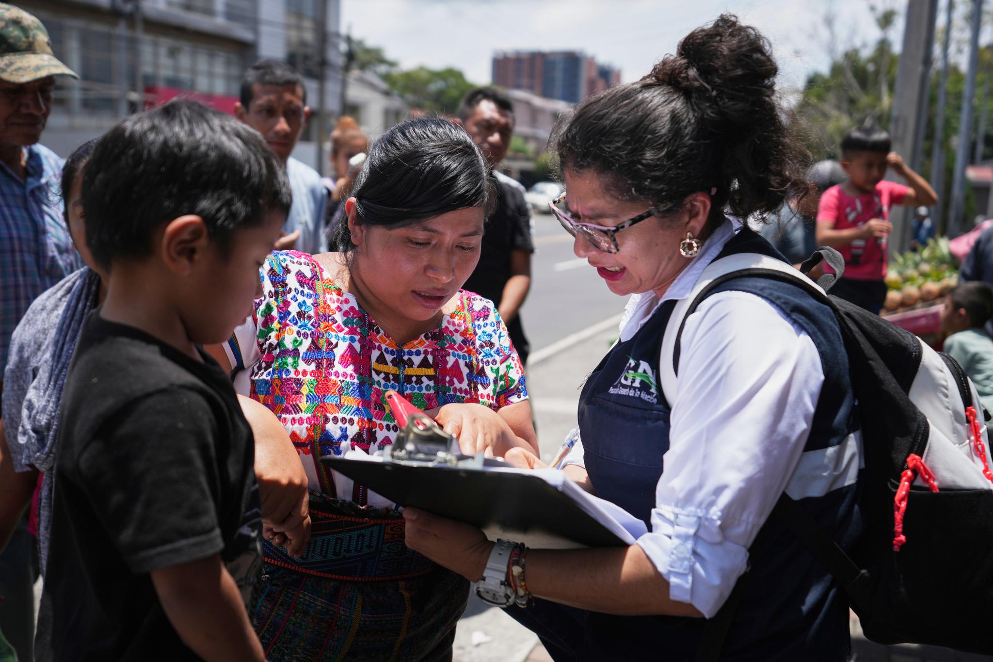 Women with a clipboard and children
