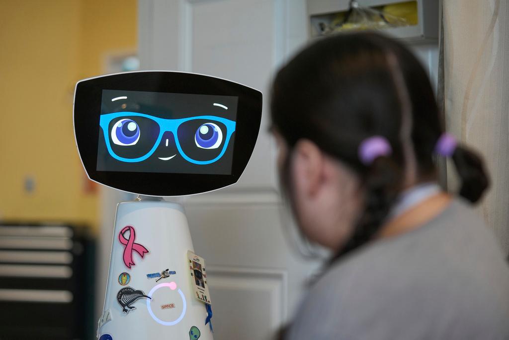 Robin the Robot visits with a patient at the HealthBridge Orange Specialty Pediatric Hospital in Orange, Calif.