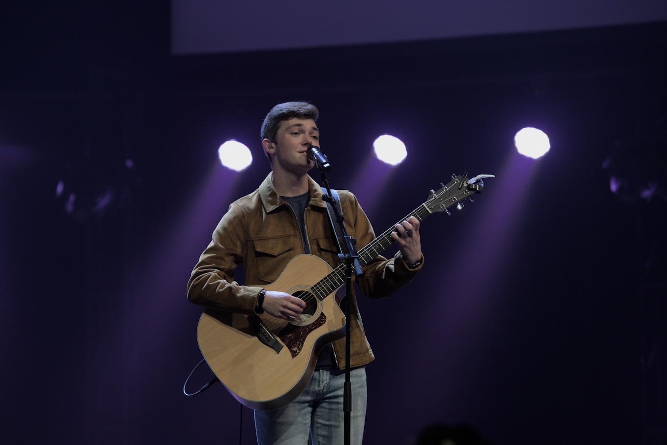 Student singing and playing the guitar at Cedarville University 