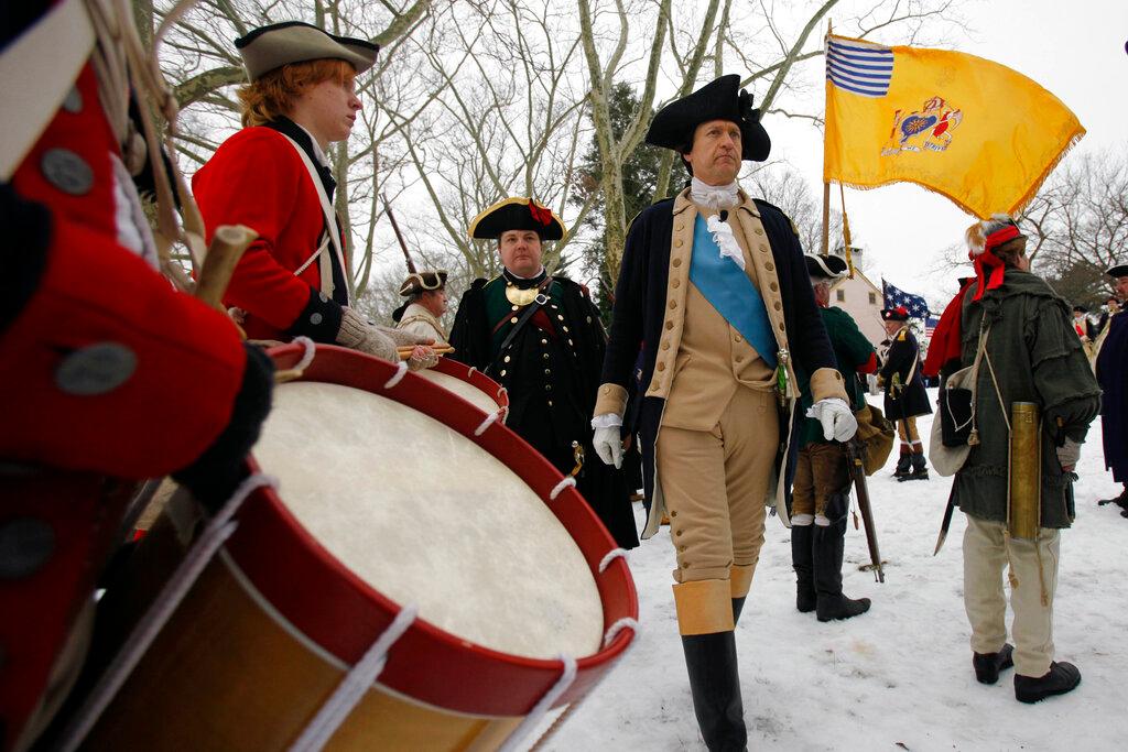 John Godzieba, right, portraying Gen. George Washington, inspects his troops during a re-enactment of Washington's historic crossing of the Delaware River