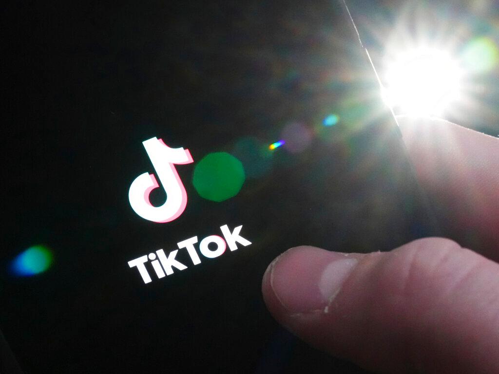 TikTok startup page is displayed on an iPhone