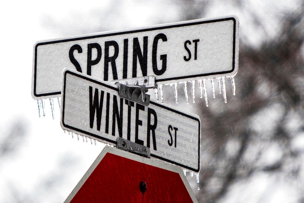 Freezing rain coats road signs for Winter and Spring streets in Spring Lake, Mich.