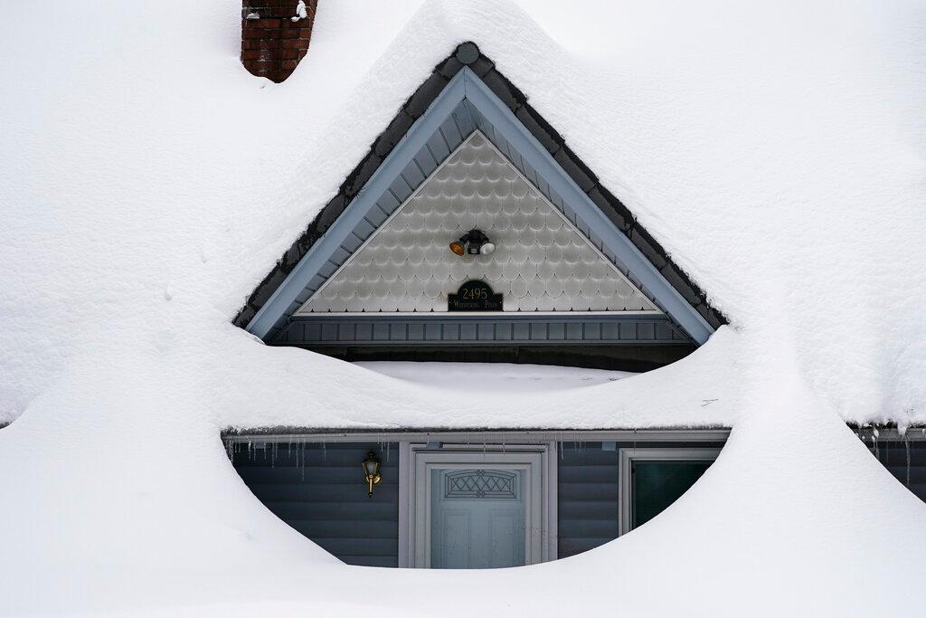 Snow is piled up on a home in Running Springs, Calif.