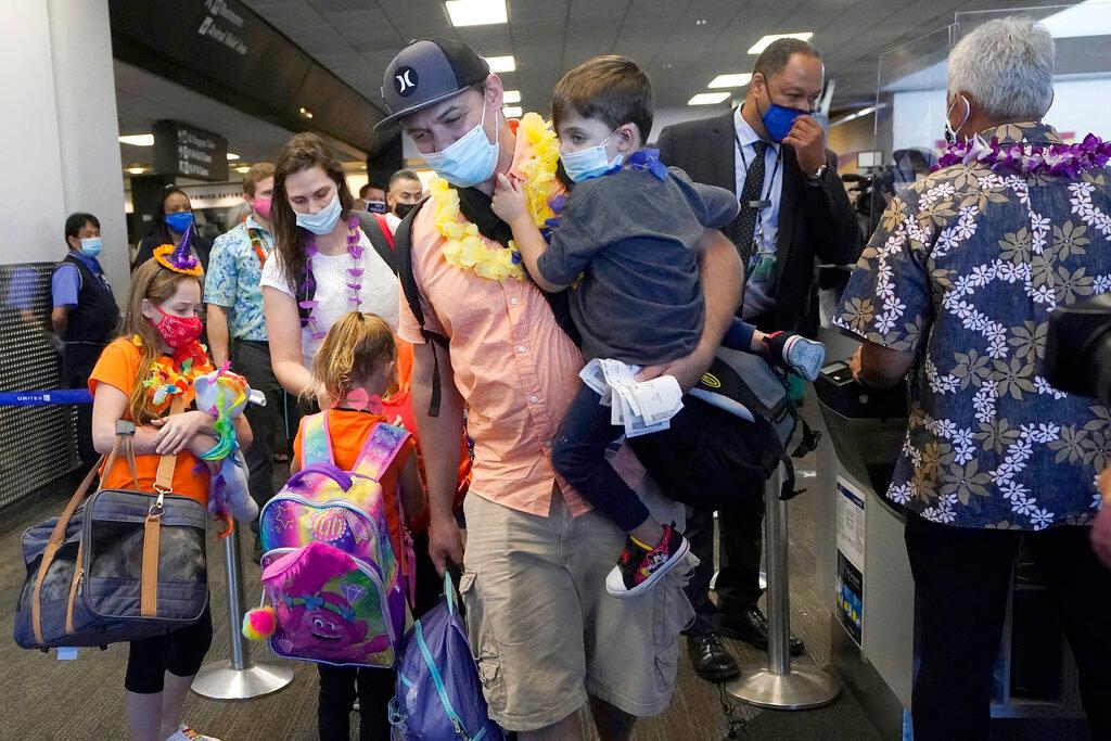 Family boards a flight to Hawaii at San Francisco International Airport 