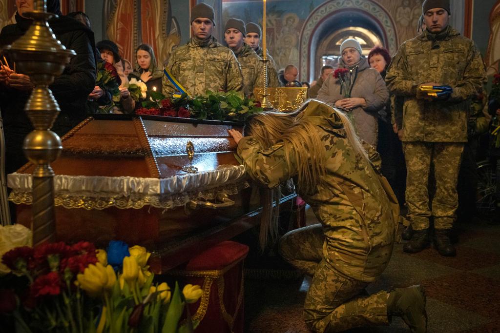 People pay last respect at the coffin of Ukrainian serviceman Oleksiy Sokolovskyi during the funeral ceremony in St. Michael Cathedral 