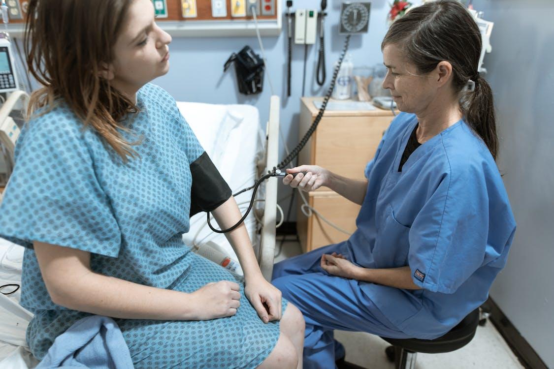 Nurse checking blood pressure