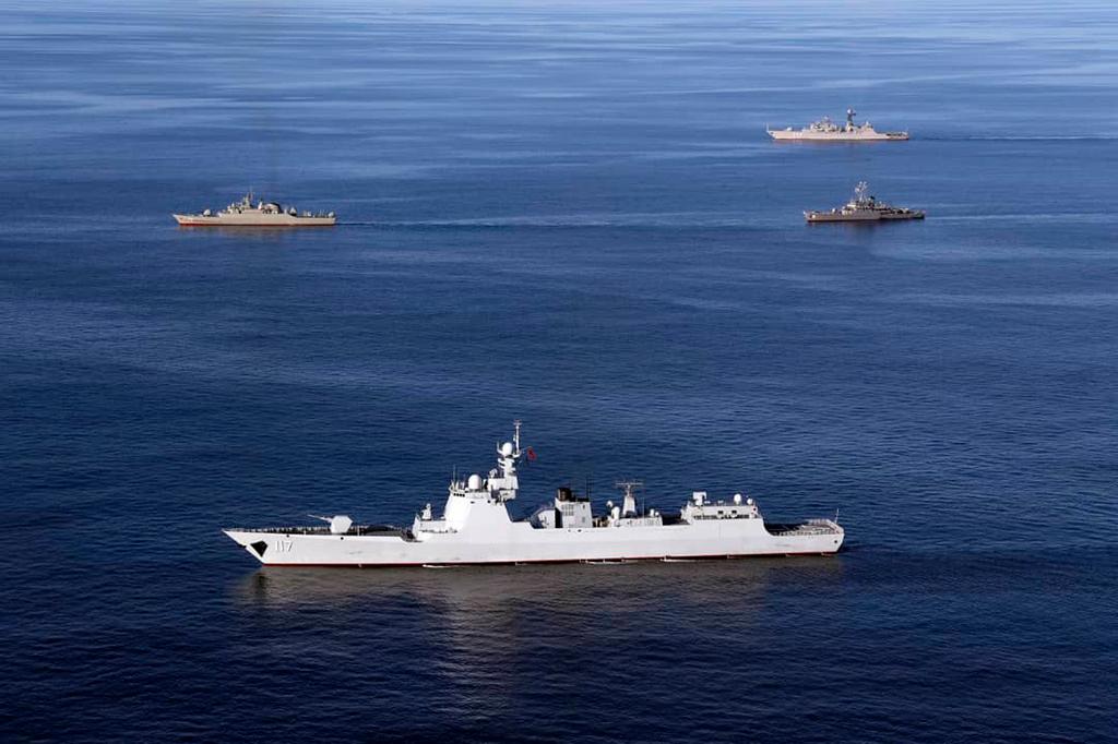 Warships sail in the Sea of Oman during the second day of joint Iran, Russia and China naval war games