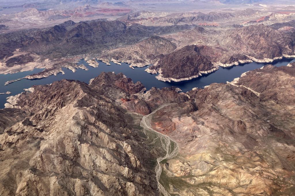 Aa bathtub ring of light minerals show the high water mark on the shore of Lake Mead along the border of Nevada and Arizona