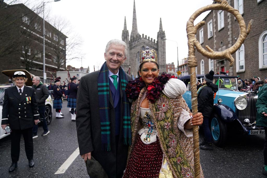 US actor Patrick Duffy poses for a photo with a performer, ahead of the St Patrick's Day Parade in Dublin, Friday March 17, 2023. 