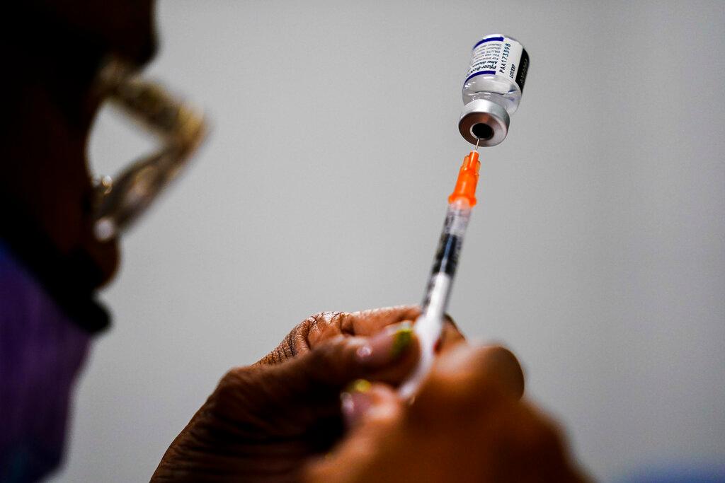 Man with vaccine in hand