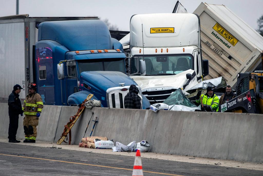 Emergency personnel cleanup after a massive pileup on Interstate 35 on Feb. 11, 2021, near downtown Fort Worth, Texas