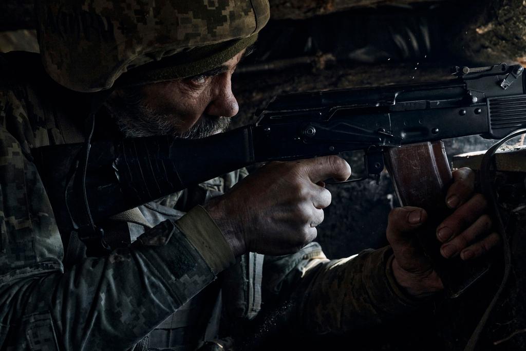 A Ukrainian soldier of the 28th brigade fires on the frontline during a battle with Russian troops at the frontline near Bakhmut, Donetsk region, Ukraine, Friday, March 24, 2023.
