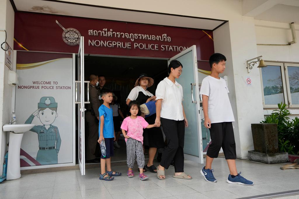 Members of the Shenzhen Holy Reformed Church, also known as the Mayflower Church, leave from the Nongprue police station on their way to Pattaya Provincial Court in Pattaya, Thailand
