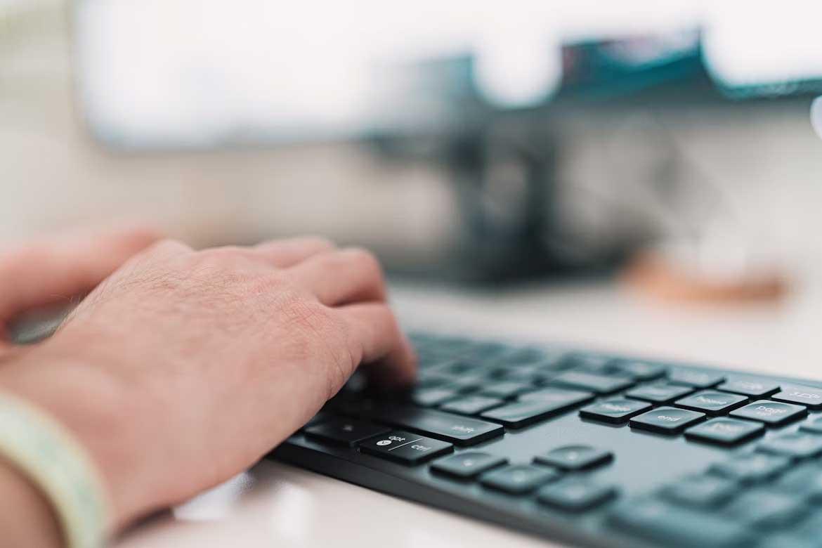 Man typing on computer