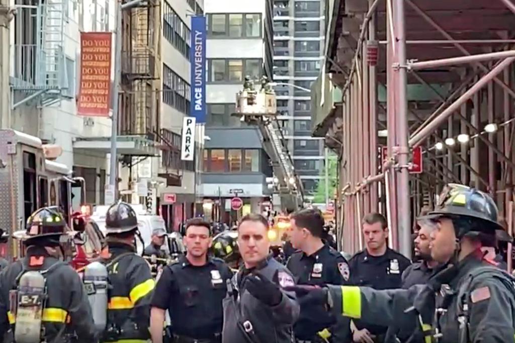 ew York City Police and Fire Department personnel cordon off an area in New York's Financial District