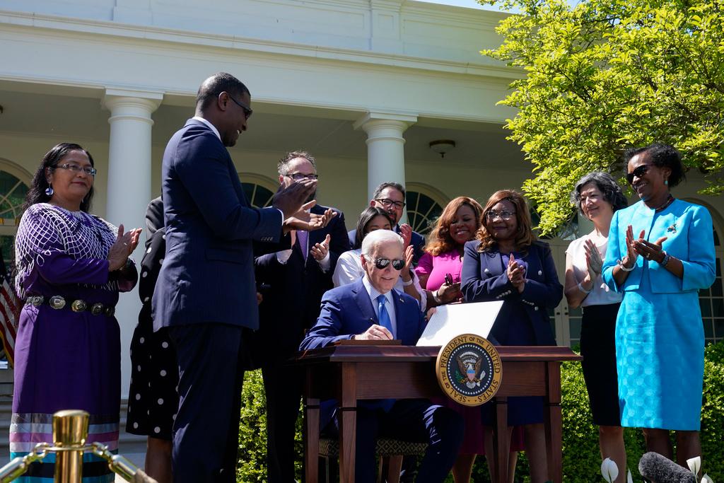 President Joe Biden signs an executive order that would create the White House Office of Environmental Justice in the Rose Garden of the White House in Washington, Friday, April 21, 2023.