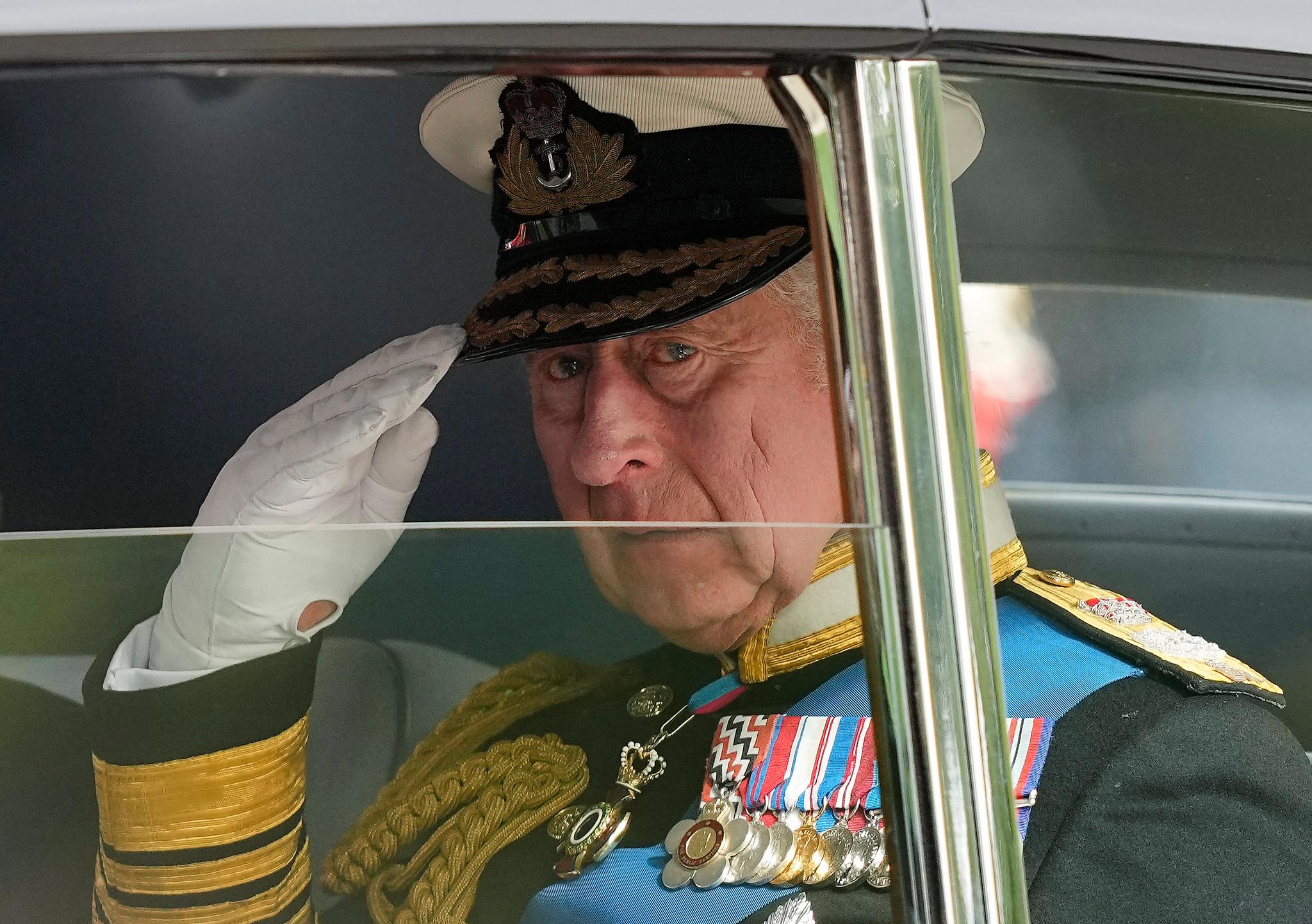 King Charles III salutes as he leaves Westminster Abbey following the state funeral service of Queen Elizabeth II in Westminster Abbey in central London, England, Monday Sept. 19, 2022.