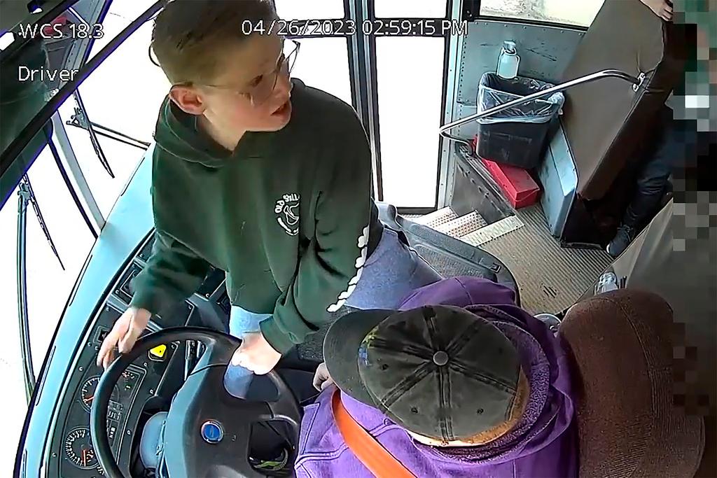 In this image made from video, seventh-grader Dillon Reeves grabs the steering wheel on his school bus and hit the brakes after the driver passed out Wednesday, April 28, 2023, Warren, Mi. Warren Consolidated Schools Superintendent Robert Livernois is calling it an “extraordinary act of courage.” 