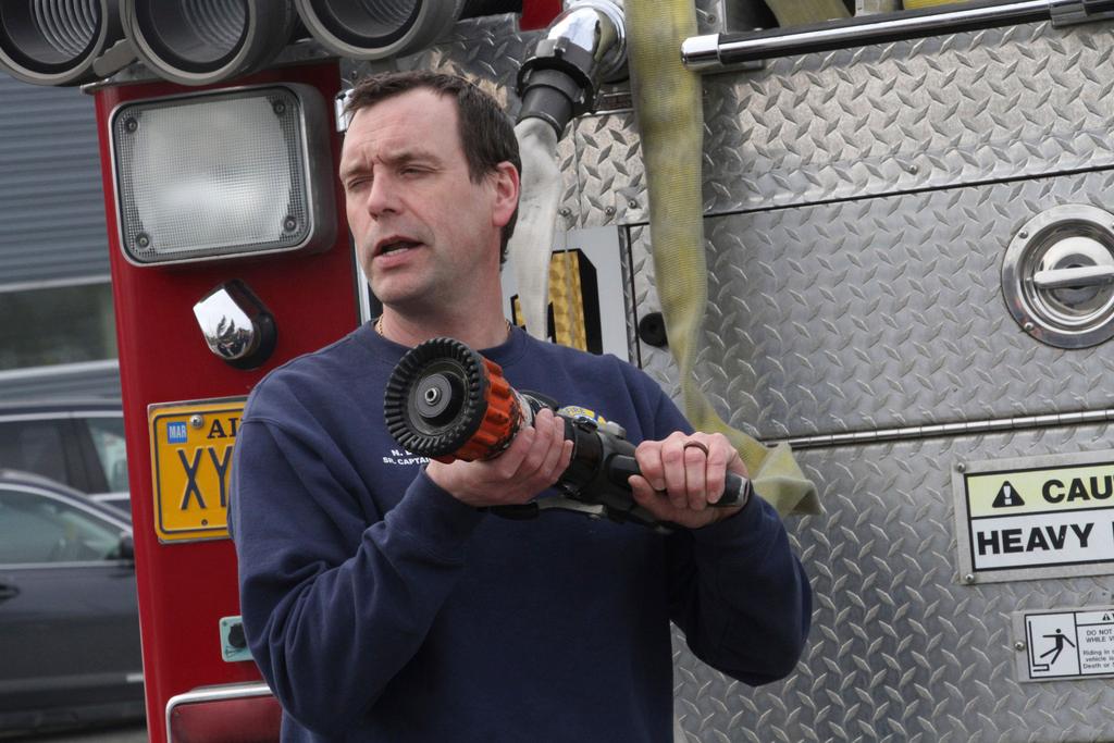 Senior Fire Captain Nick Davis demonstrates nozzles Monday, April 24, 2023, to other firefighters in Anchorage, Alaska, learning how to fight wildland fires.