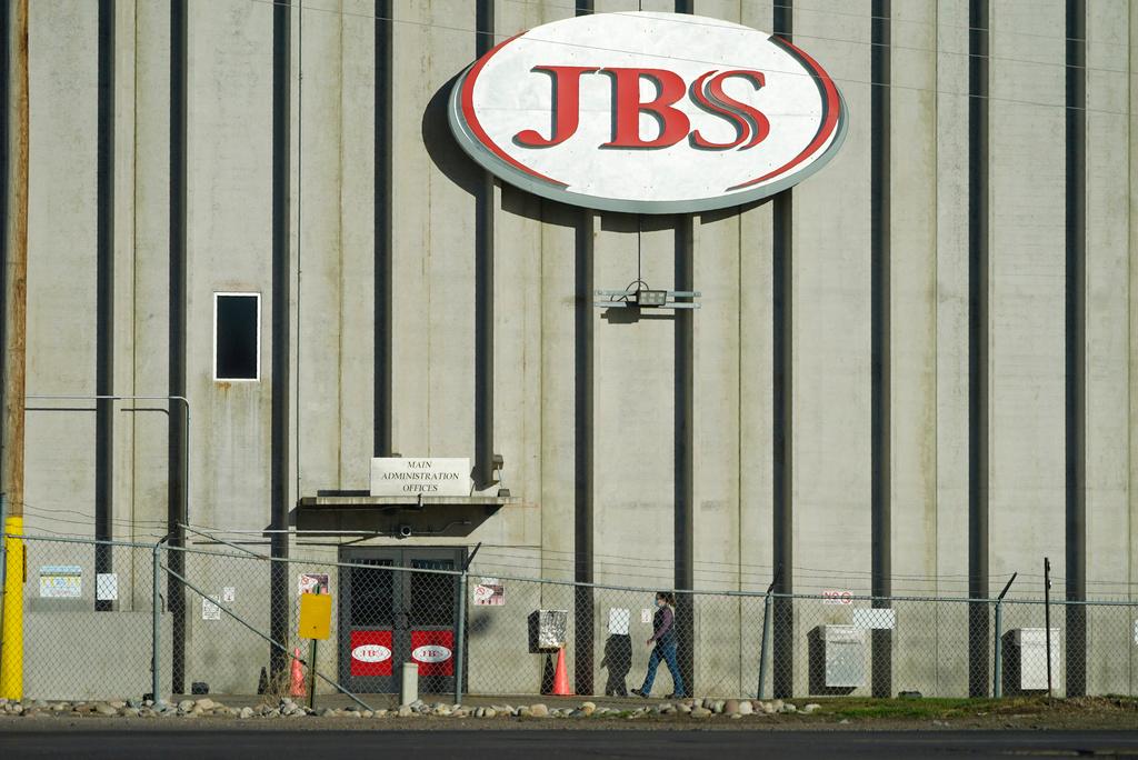 A worker heads into the JBS meatpacking plant in Greeley, Colo., Oct. 12, 2020. Packers Sanitation Services Inc. 