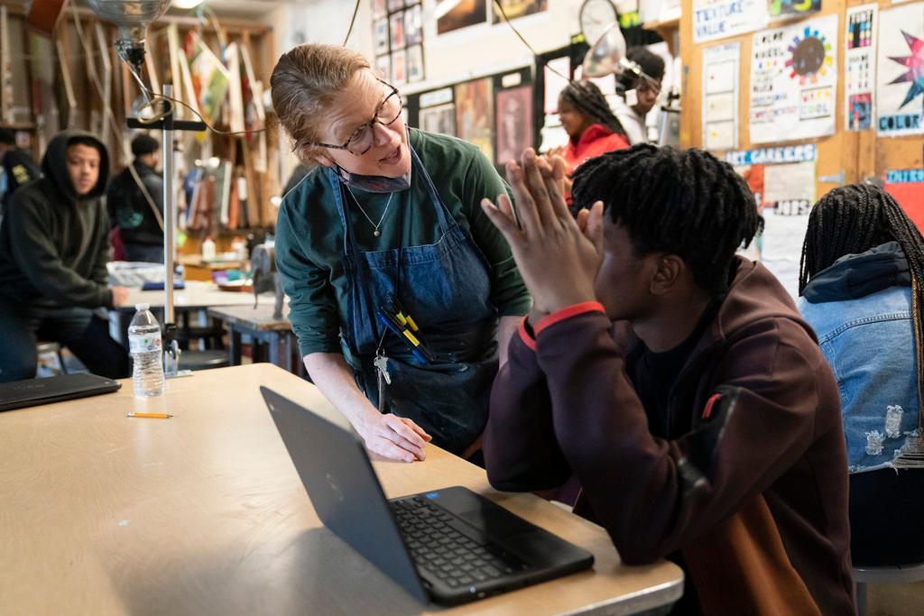 Art teacher Alyce Grunt speaks with a student at Penn Wood High School in Lansdowne, Pa.
