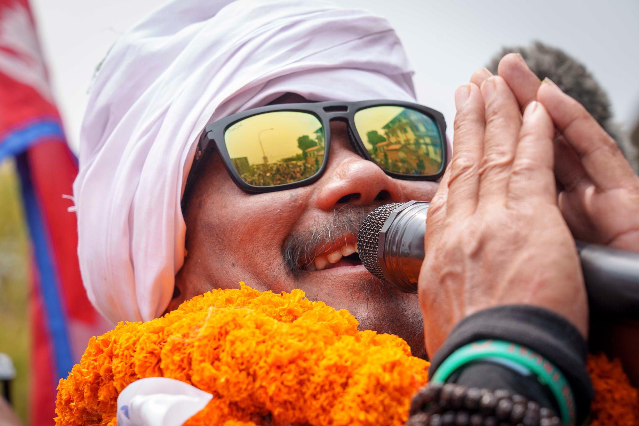 Hari Budha Magar, former Gurkha veteran and double amputee climber who scaled Mount Everest, greets the crowd upon arrival at the airport in Kathmandu, Nepal, Tuesday, May 23, 2023.