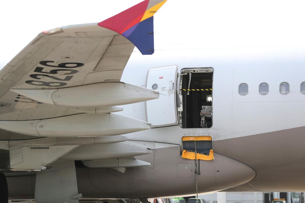 An Asiana Airlines plane is parked as one of the plane's doors suddenly opened at Daegu International Airport in Daegu, South Korea, Friday, May 26, 2023.