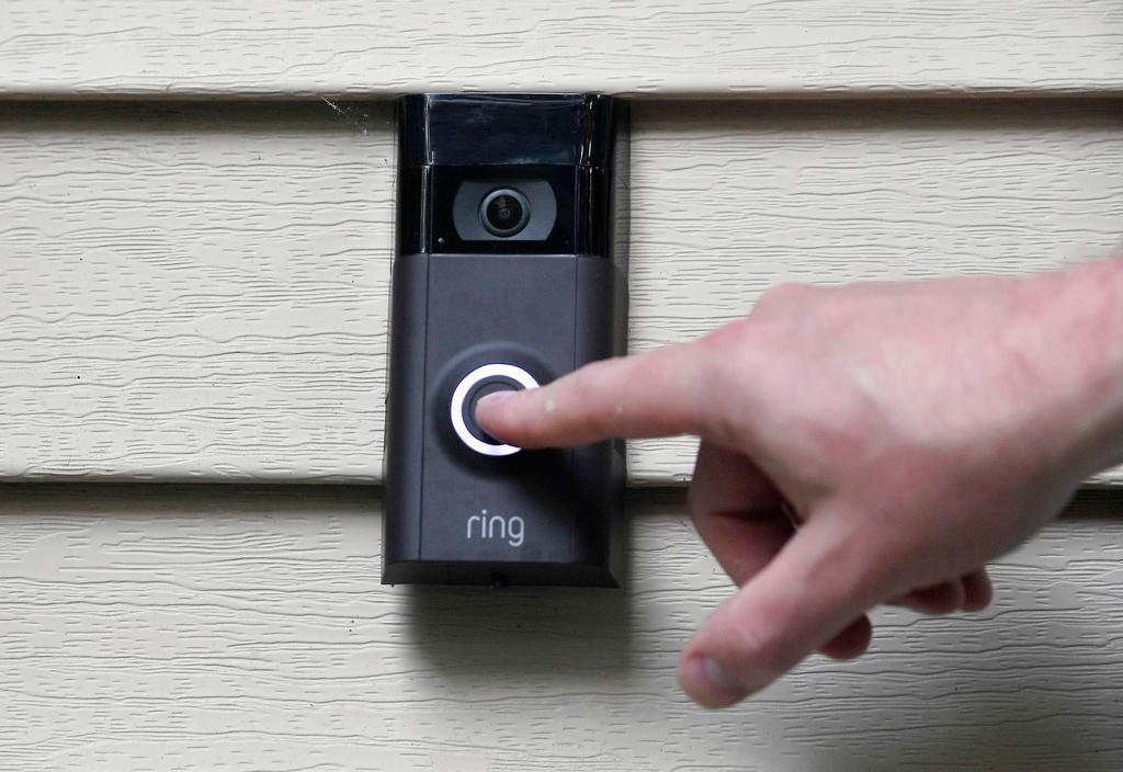 Ernie Field pushes the doorbell on his Ring doorbell camera at his home in Wolcott, Conn.