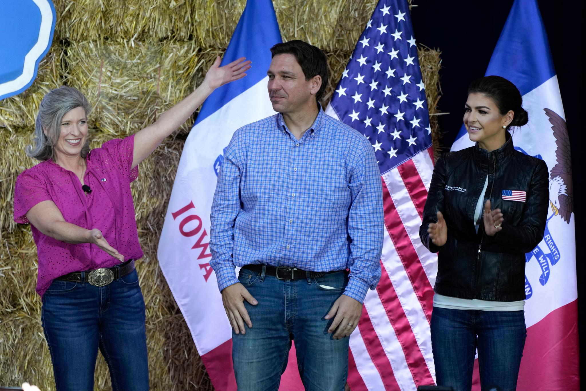 Republican presidential candidate and Florida Gov. Ron DeSantis stands on stage with his wife, Casey, right, and U.S. Sen. Joni Ernst, R-Iowa, during Ernst's Roast and Ride, Saturday, June 3, 2023, in Des Moines, Iowa.